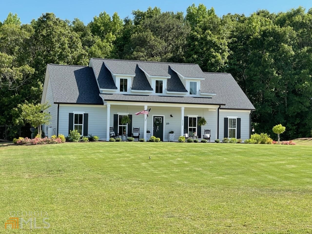 3260 Davis Academy Road Rutledge, GA 30663 - Photo 1 of 1 a front view of a house with a garden