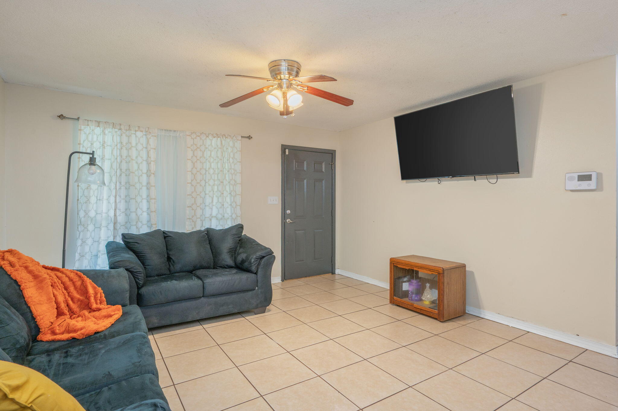 834 McDonald Street Crestview, FL 32536 - Photo 5 of 35 a living room with furniture and a flat screen tv