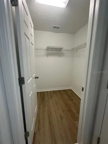 a view of a room with wooden floor