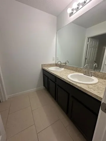 a bathroom with a granite countertop sink a mirror and a
