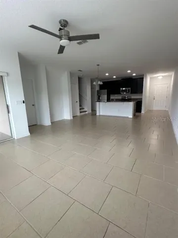 a view of a livingroom with a ceiling fan and window