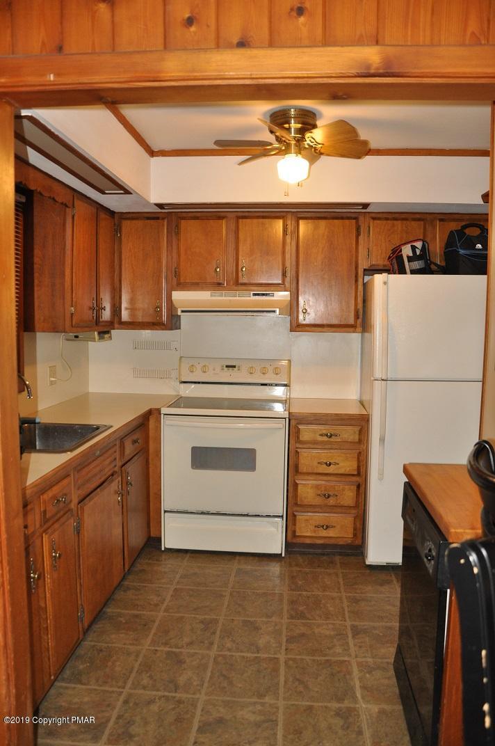 1041 Clover Road South Long Pond, PA 18334 - Photo 4 of 26 a kitchen with a stove and a refrigerator