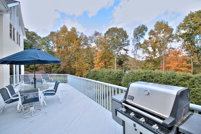 a view of a chair and tables in the balcony