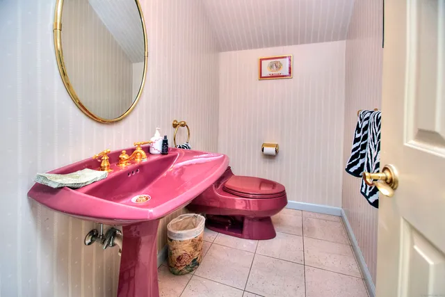 a bathroom with a bath tub sink and mirror