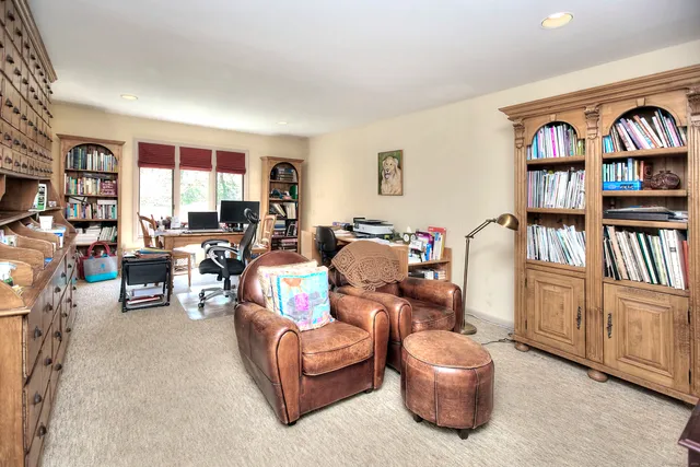 a living room with furniture and a book shelf