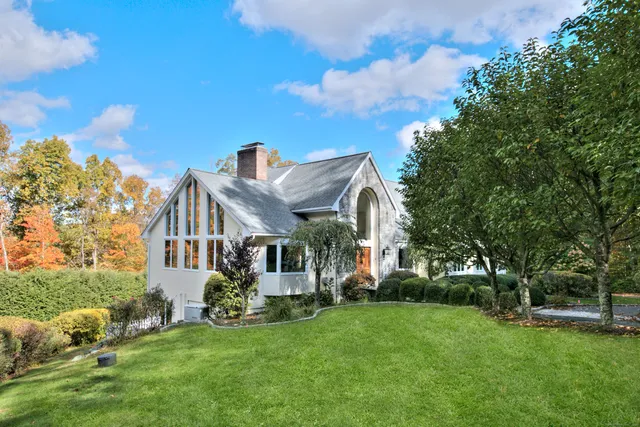 a front view of a house with a garden and plants