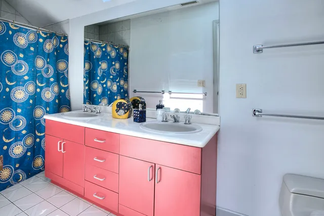 a bathroom with a sink mirror and vanity
