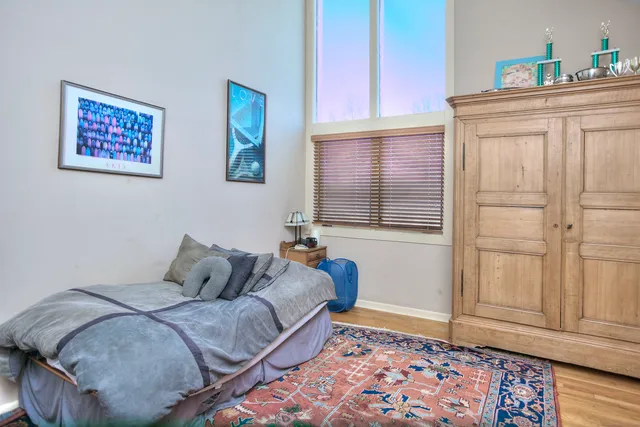a bedroom with a bed and a window