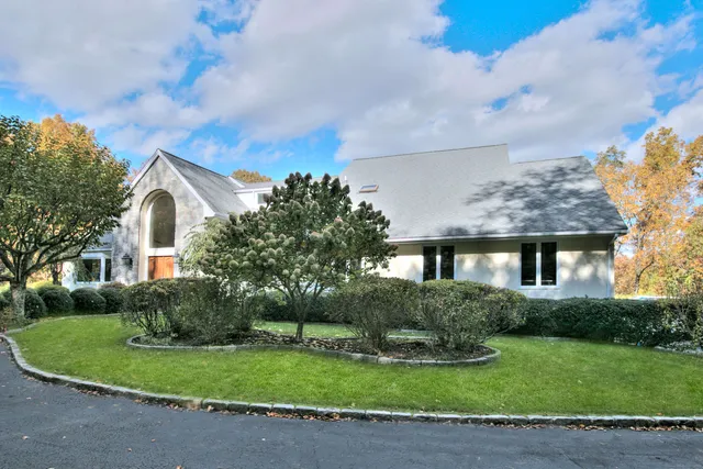 a front view of a house with a garden