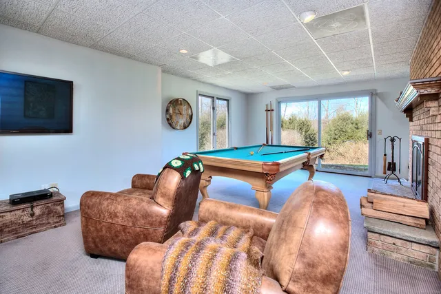 a bedroom with bed and a large window