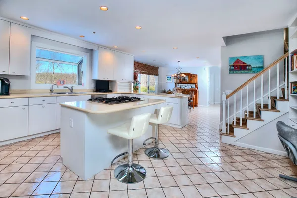 a kitchen with stainless steel appliances granite countertop a stove a sink dishwasher and a refrigerator with cabinets