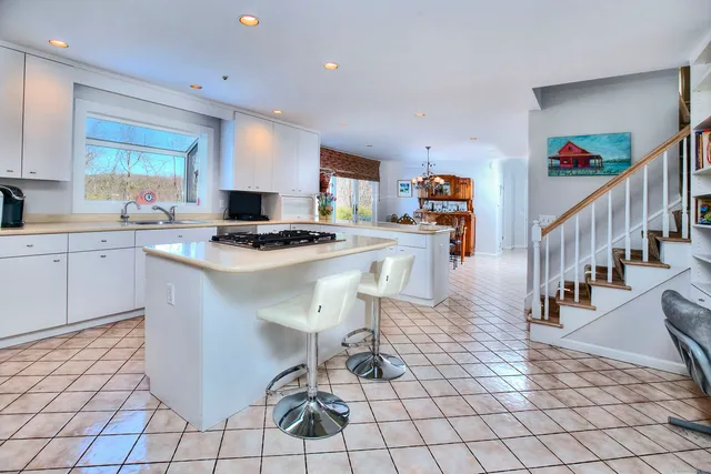 a kitchen with stainless steel appliances granite countertop a stove a sink dishwasher and a refrigerator with cabinets