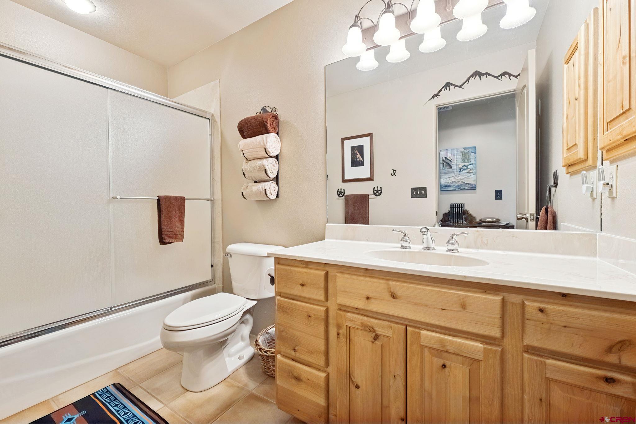 55 Edgemont Way Durango, CO 81301 - Photo 15 of 27 a bathroom with a sink vanity mirror and toilet