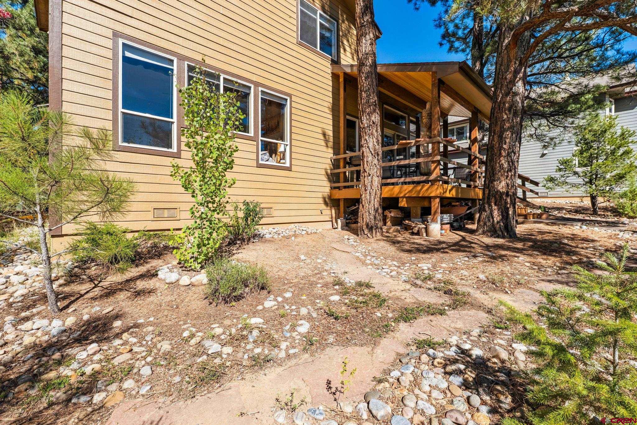55 Edgemont Way Durango, CO 81301 - Photo 20 of 27 a backyard of a house with barbeque oven table and chairs