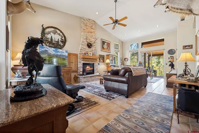 a living room with furniture a fireplace and a chandelier