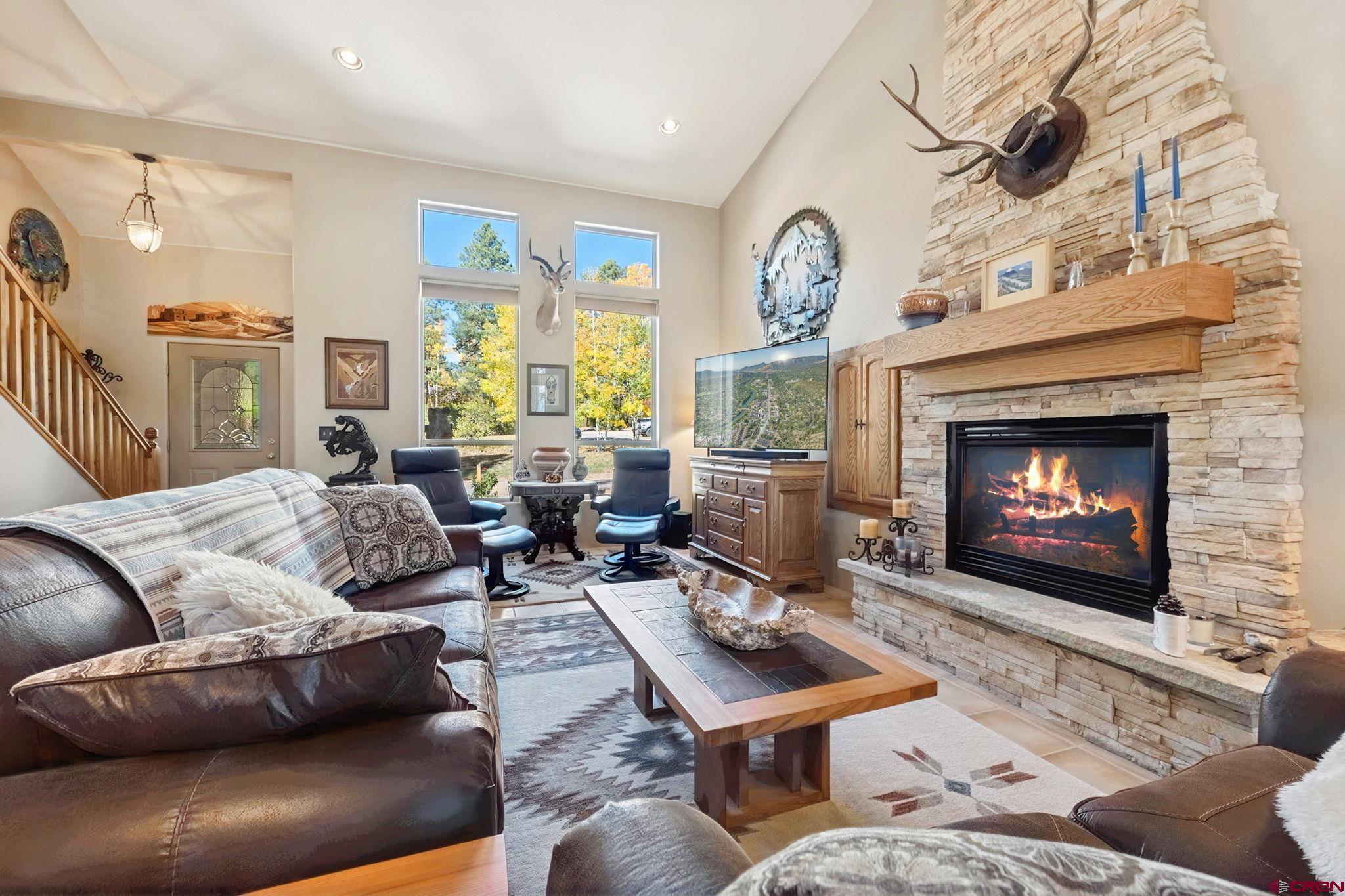 55 Edgemont Way Durango, CO 81301 - Photo 3 of 27 a living room with furniture fireplace and a large window