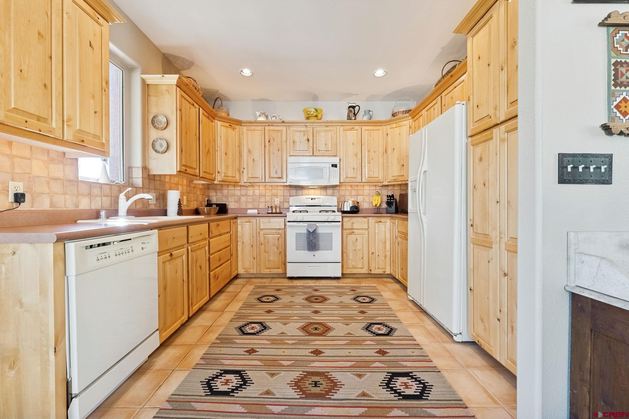 55 Edgemont Way Durango, CO 81301 - Photo 6 of 27 a kitchen with a stove a sink and a refrigerator