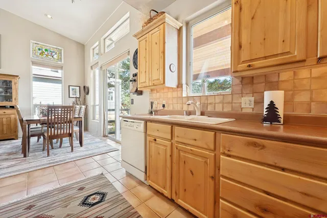 a kitchen with sink cabinets and dining table
