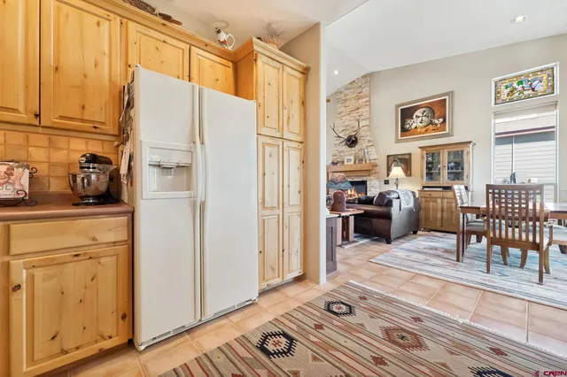 a living room with furniture a dining table and chairs with wooden floor
