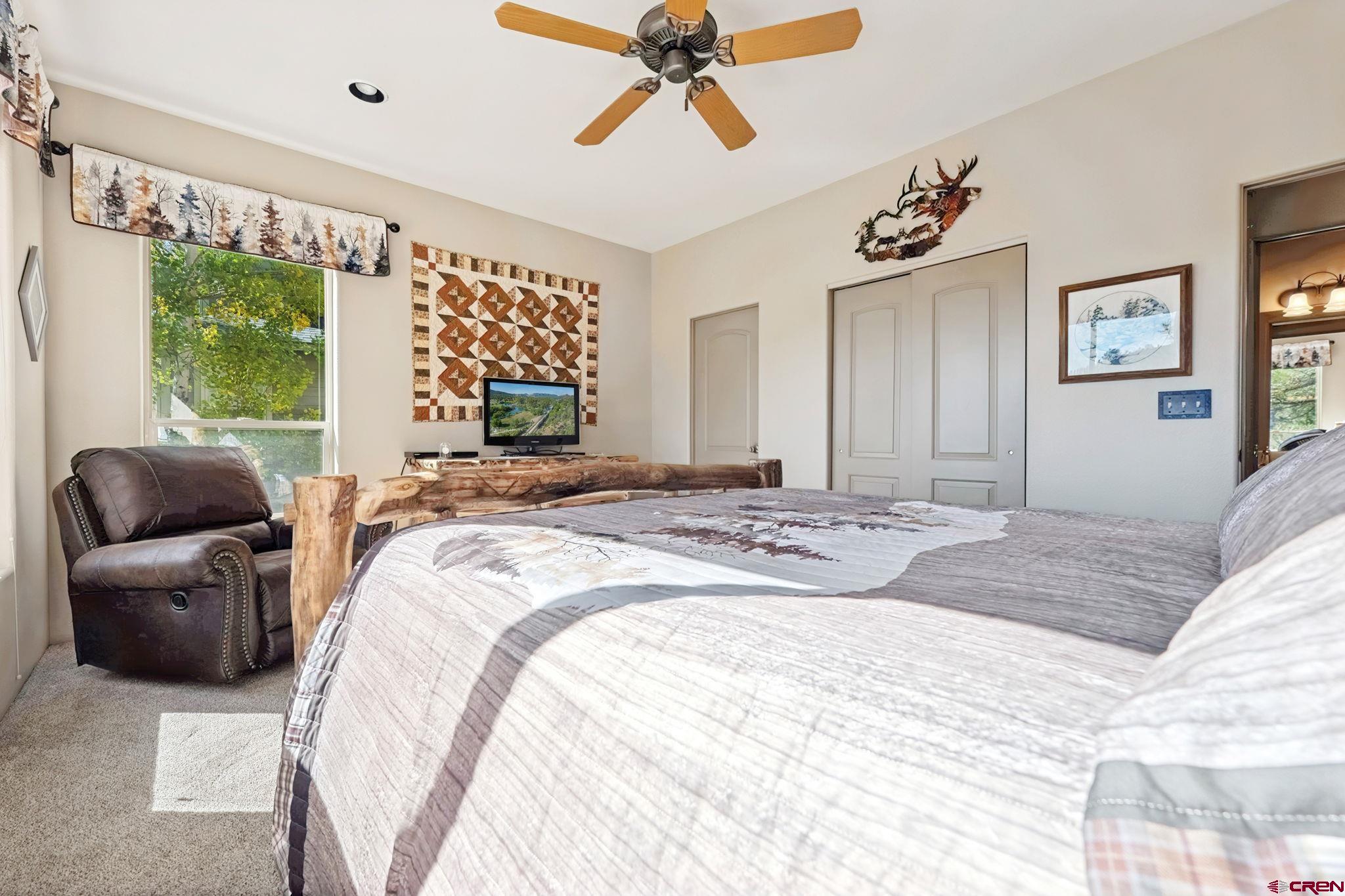 55 Edgemont Way Durango, CO 81301 - Photo 10 of 27 a bedroom with a bed couch and window