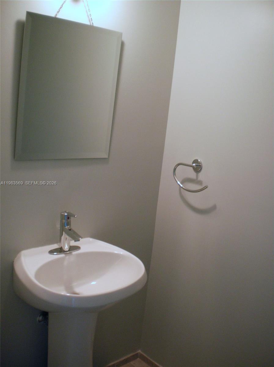 60 Southwest 13th Street, Unit 1806 Miami, FL 33130 - Photo 11 of 12 a sink with a mirror