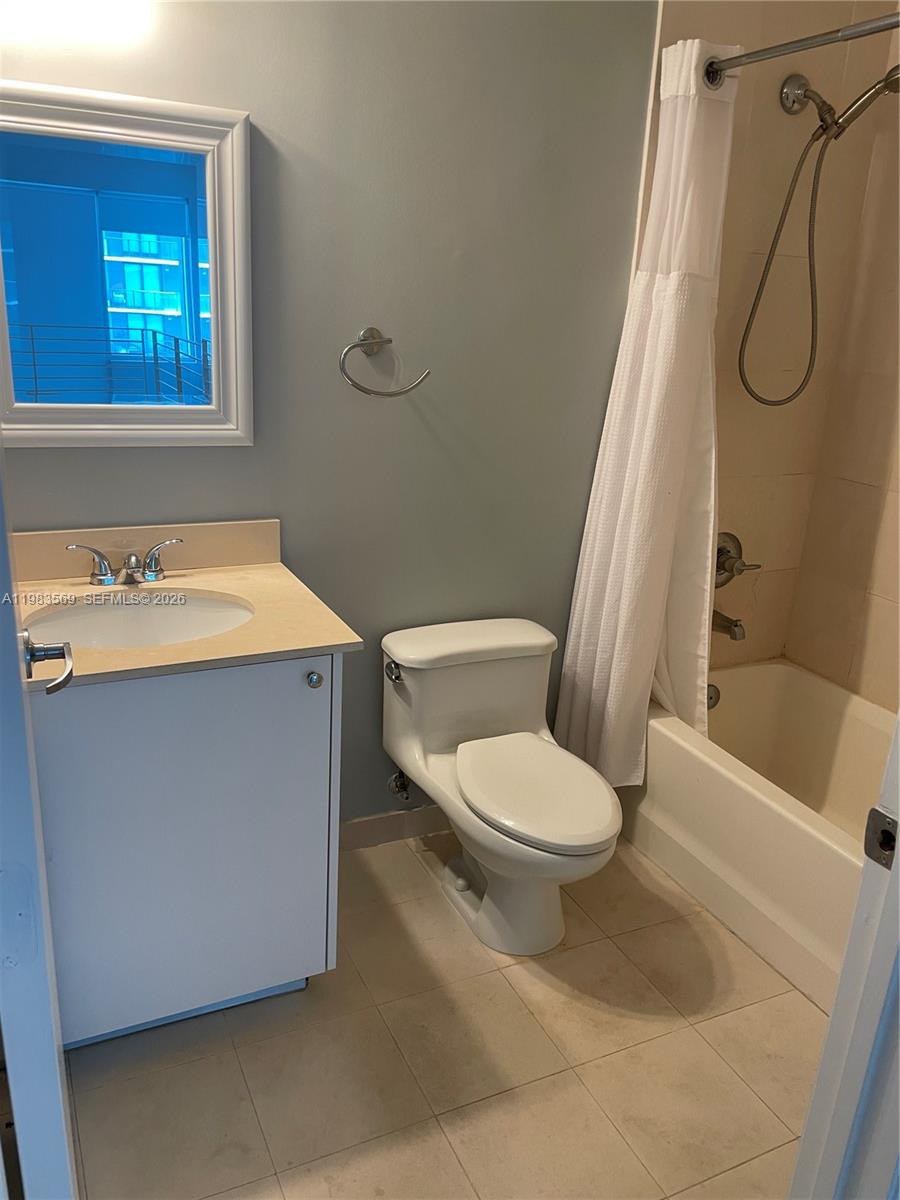 60 Southwest 13th Street, Unit 1806 Miami, FL 33130 - Photo 9 of 12 a white toilet sitting next to a bath tub shower
