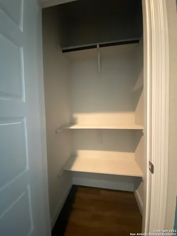 a large living room with stainless steel appliances kitchen view and a refrigerator