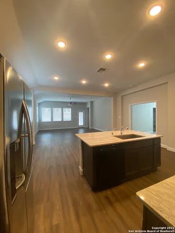 a view of living room with stainless steel appliances kitchen island