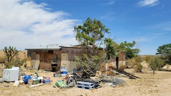 a view of a chairs and table in the patio