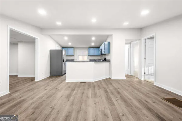 a kitchen with granite countertop a stove top oven sink and cabinets