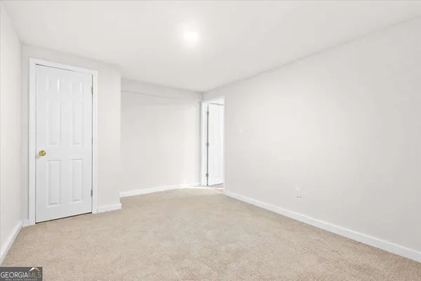 a view of an empty room and a window