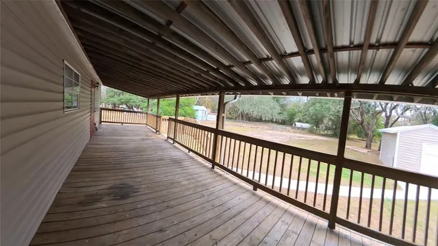 a view of a porch with wooden floor