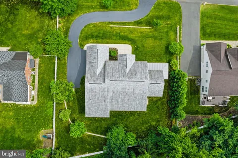 a front view of a house with a yard and potted plants