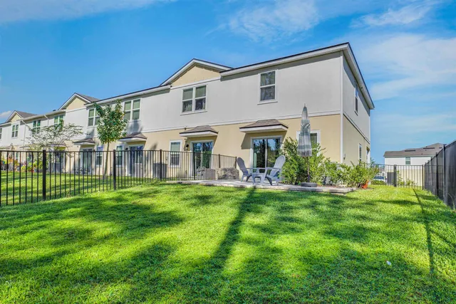 a view of a house with a big yard and garden