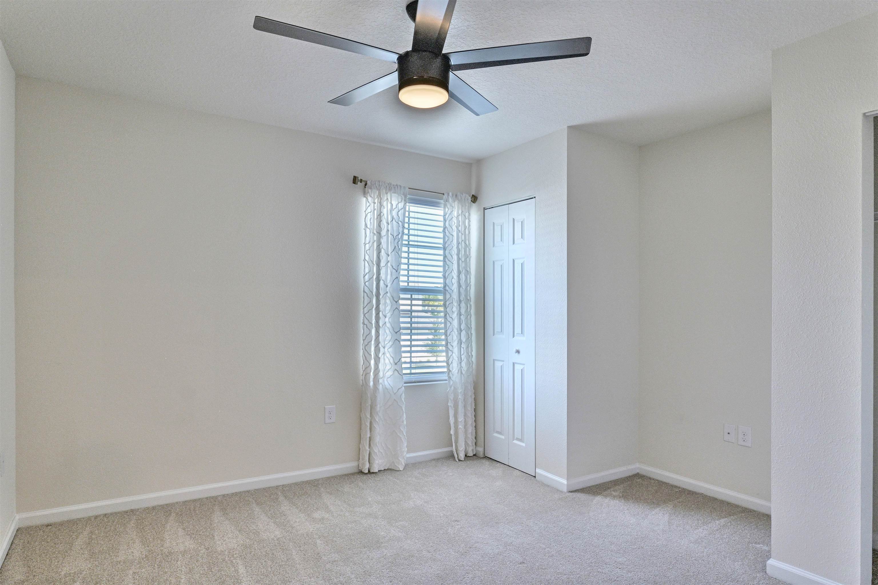 297 Coastline Way Street St. Augustine, FL 32092 - Photo 13 of 36 an empty room with windows and fan
