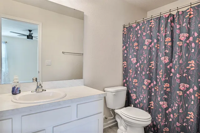 a bathroom with a sink toilet and a mirror