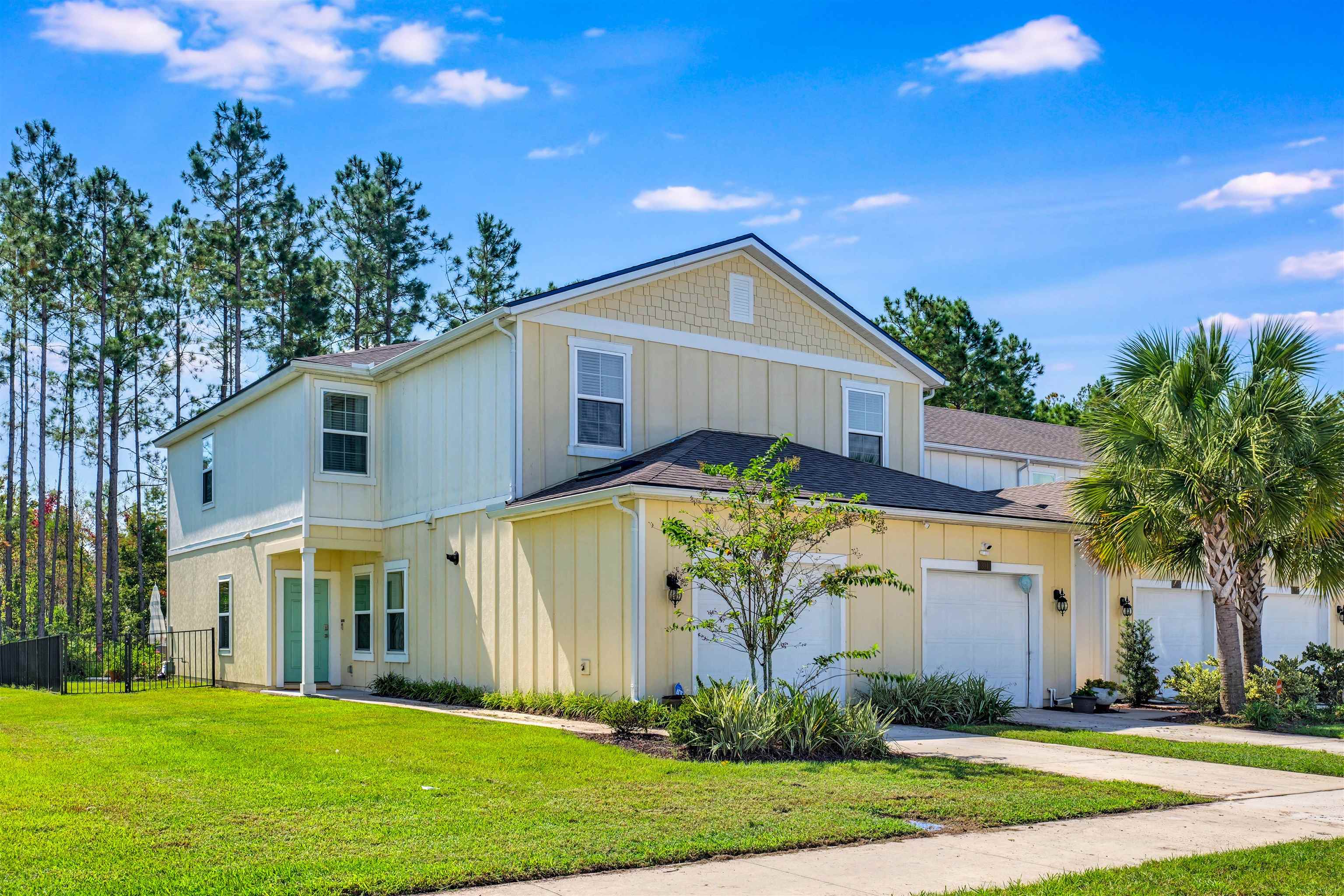 297 Coastline Way Street St. Augustine, FL 32092 - Photo 2 of 36 a front view of yellow house with a yard