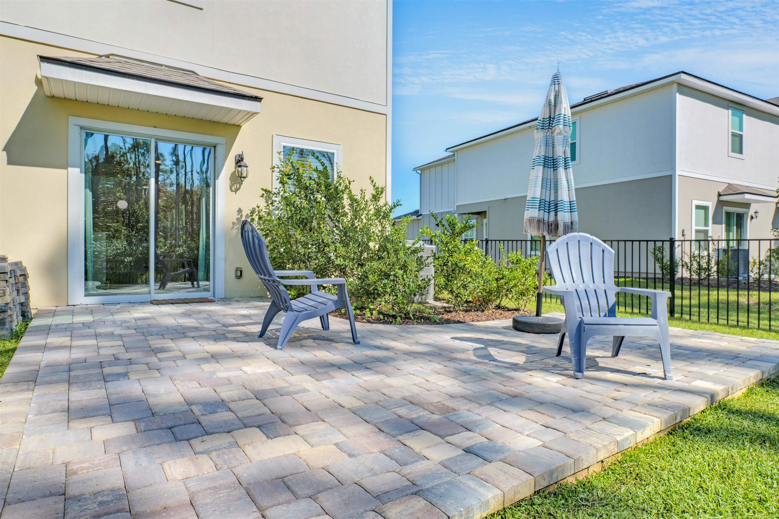 297 Coastline Way Street St. Augustine, FL 32092 - Photo 21 of 36 a view of a chair and table in backyard of the house