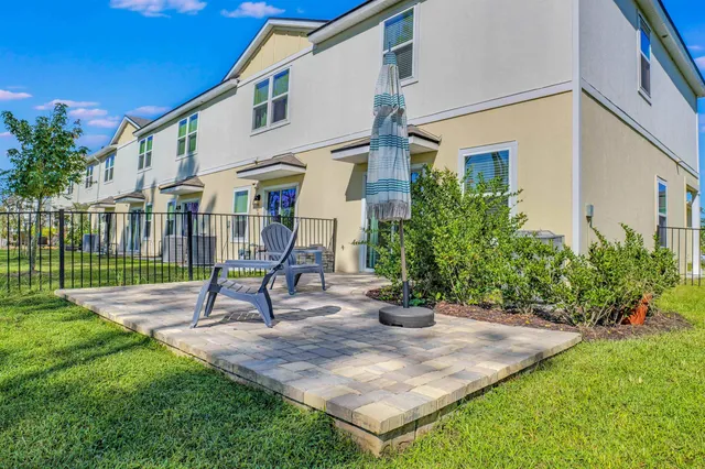a view of a house with a yard and sitting area