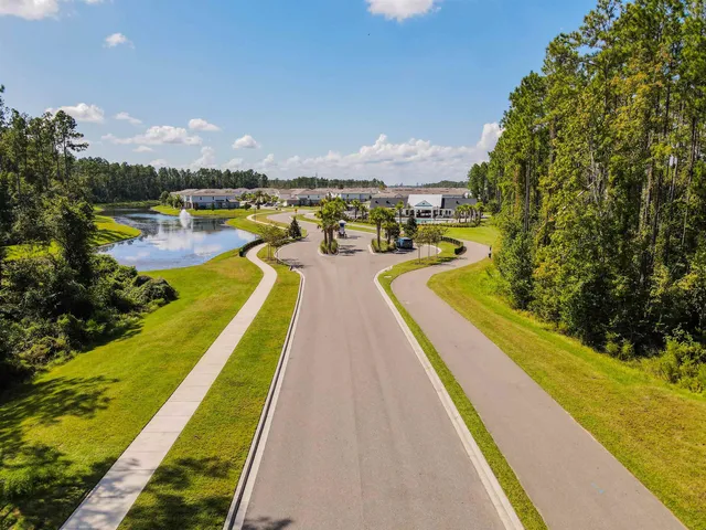 an aerial view of a swimming pool with lawn chairs and plants