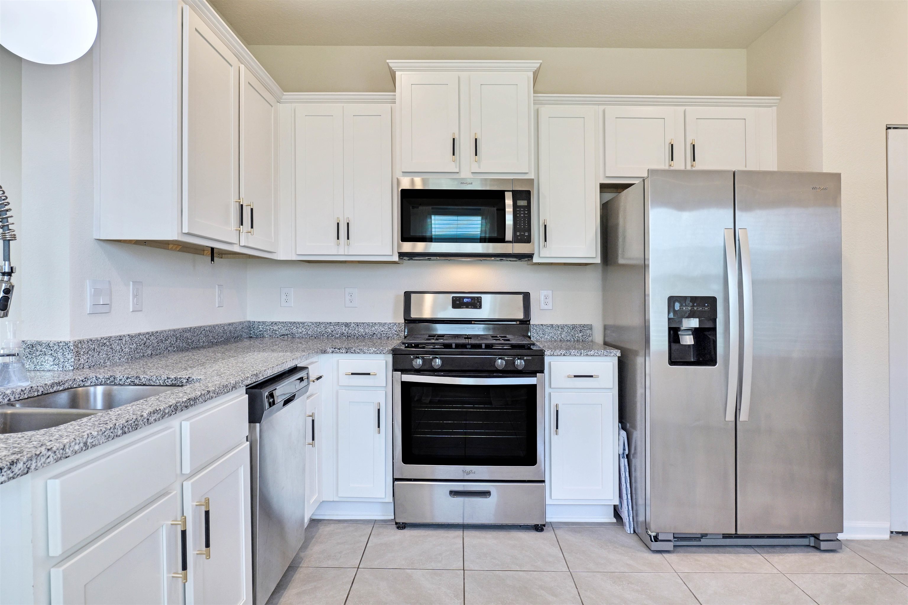 297 Coastline Way Street St. Augustine, FL 32092 - Photo 4 of 36 a kitchen with stainless steel appliances granite countertop a stove a refrigerator and a sink