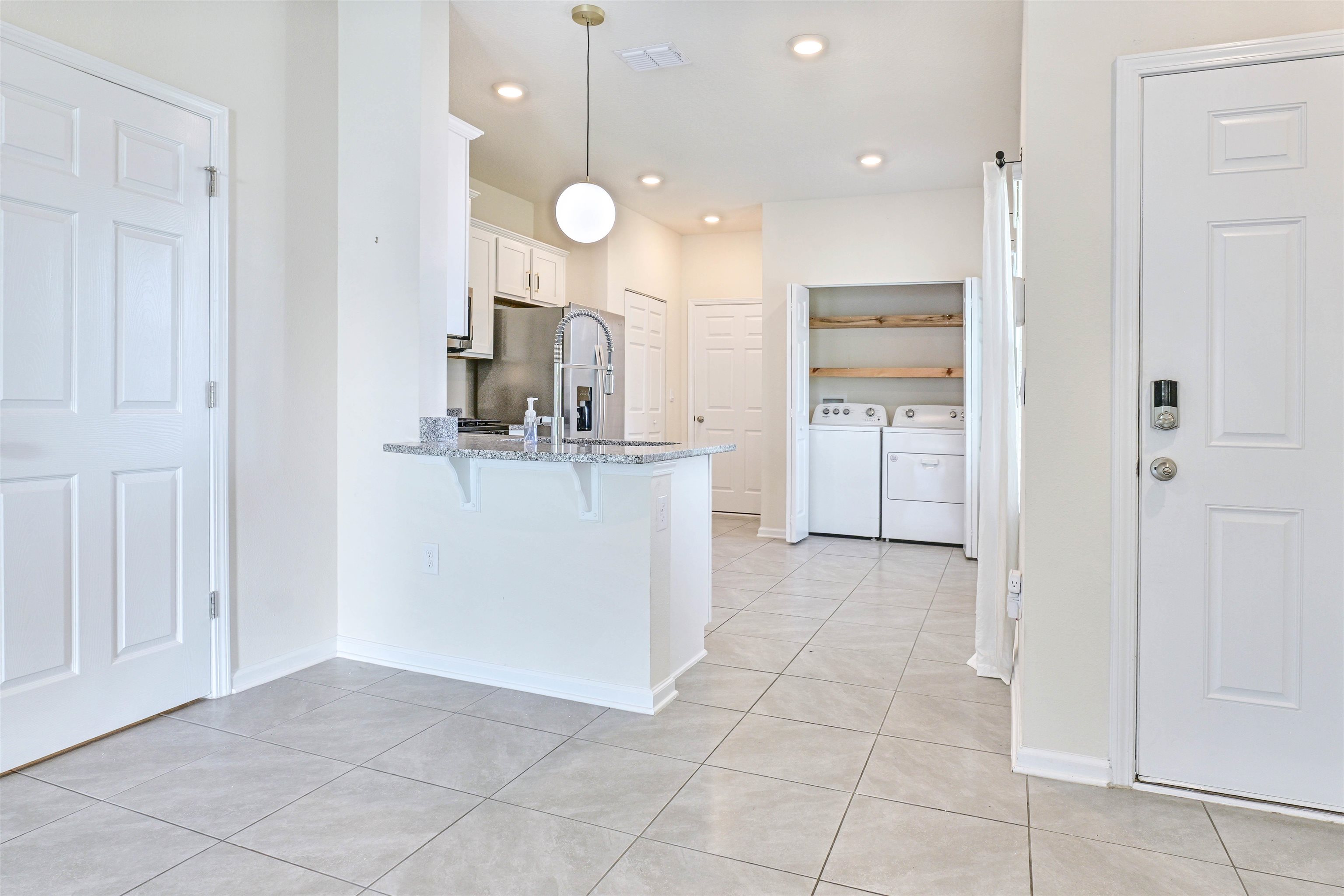 297 Coastline Way Street St. Augustine, FL 32092 - Photo 5 of 36 a view of a kitchen with refrigerator and microwave