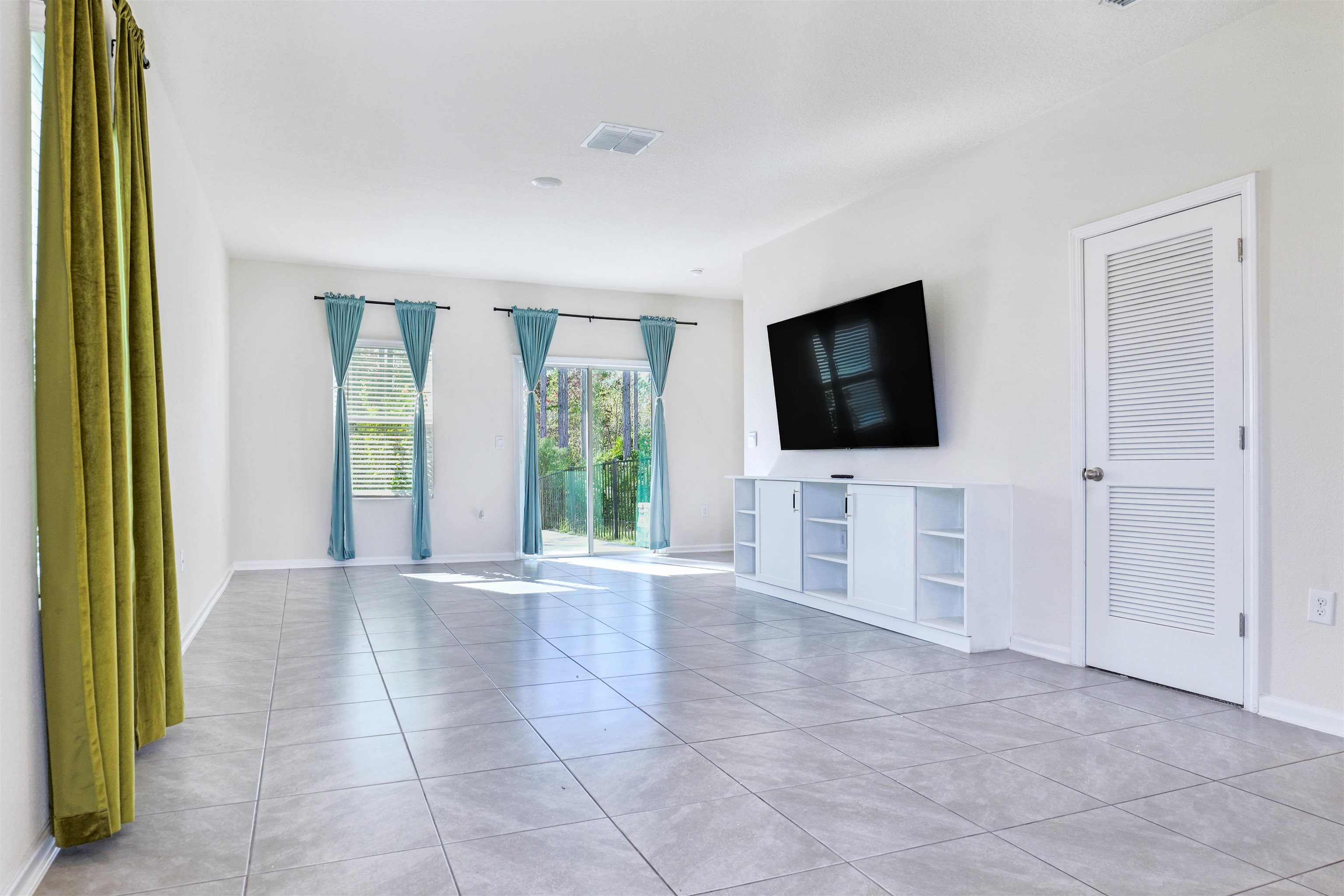 297 Coastline Way Street St. Augustine, FL 32092 - Photo 6 of 36 wooden floor to ceiling window and flat screen tv