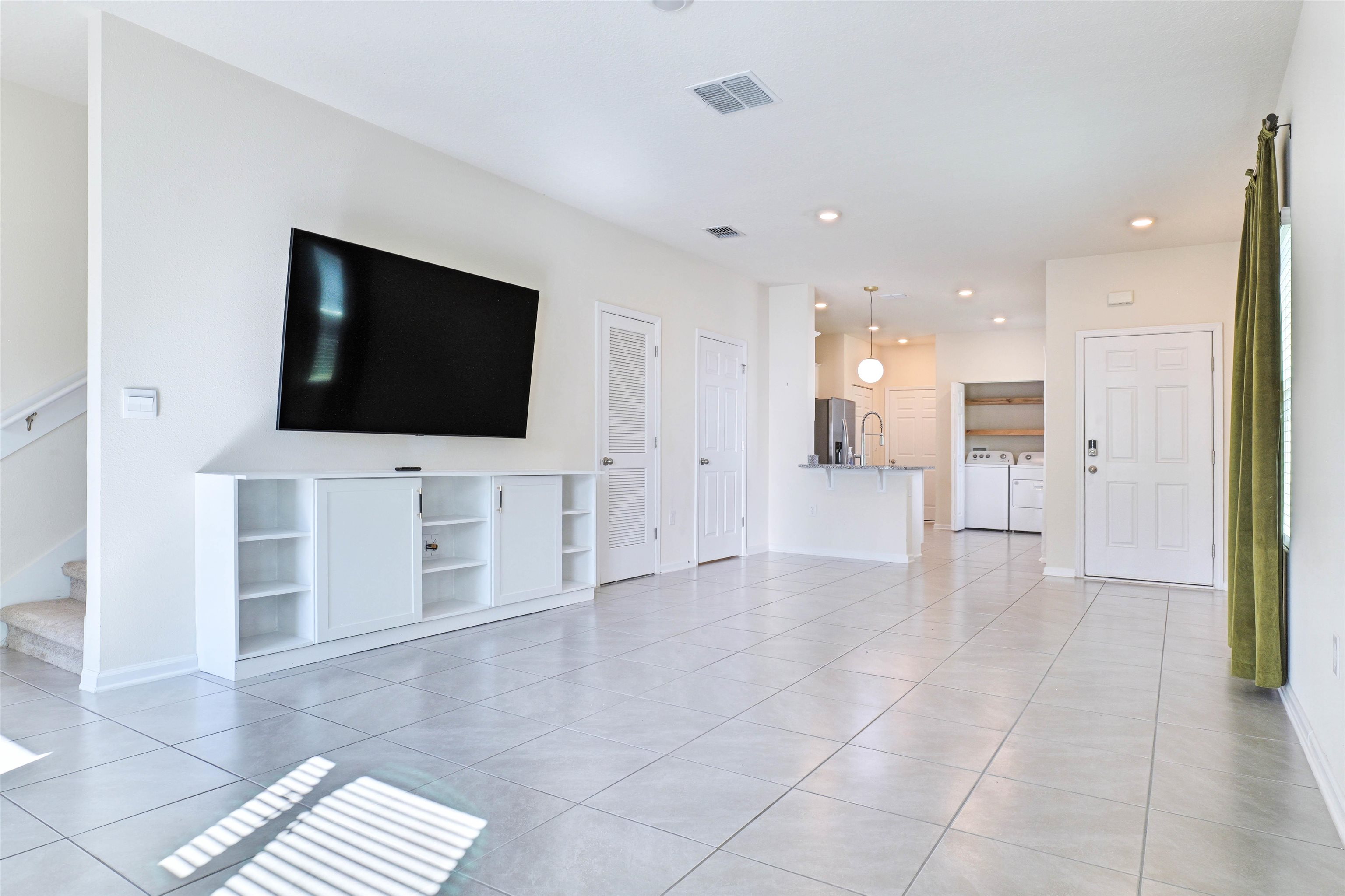 297 Coastline Way Street St. Augustine, FL 32092 - Photo 7 of 36 a view of a livingroom with an empty space and a kitchen