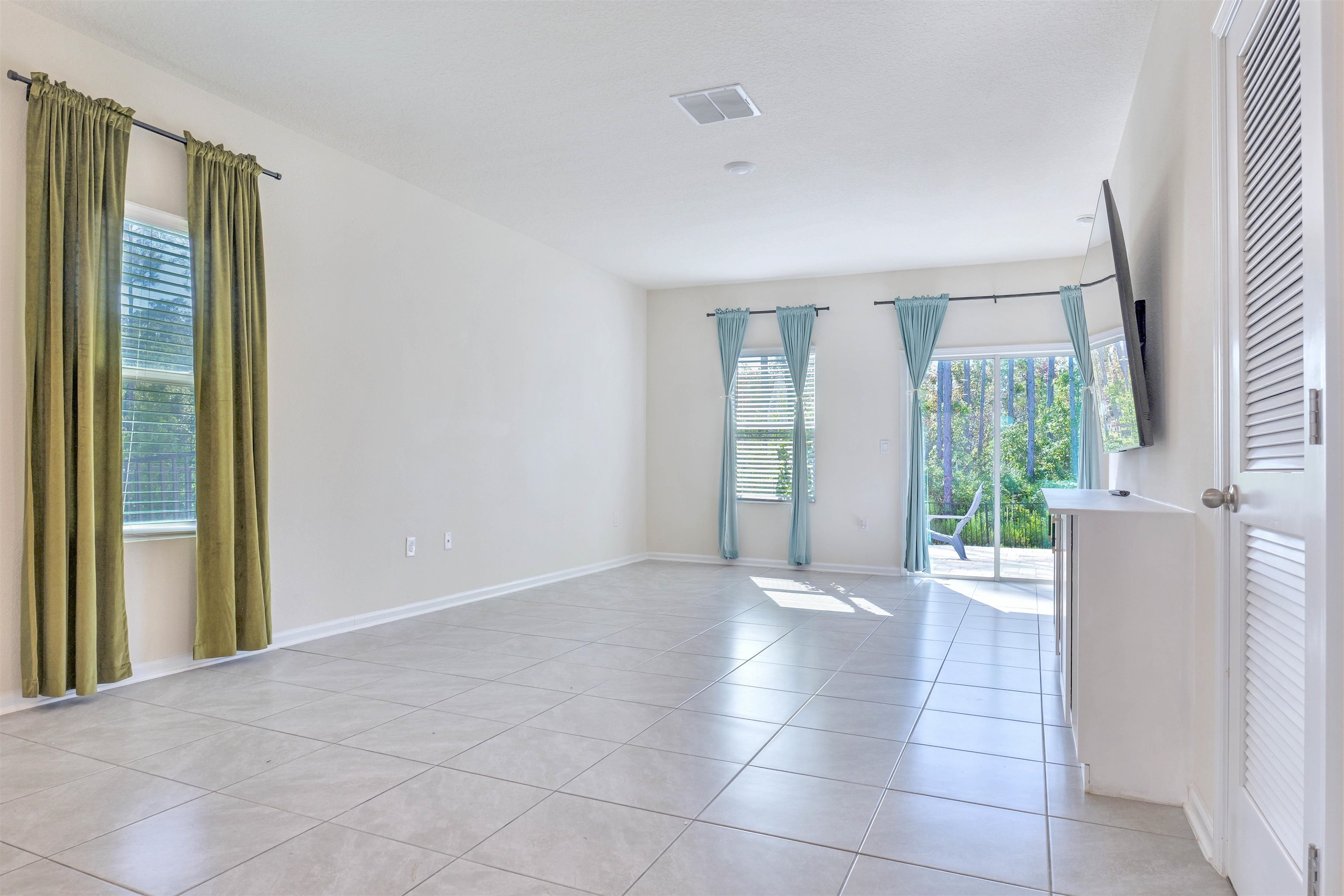 297 Coastline Way Street St. Augustine, FL 32092 - Photo 9 of 36 a view of an empty room with a window