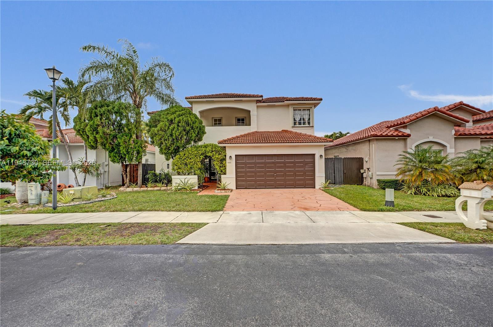 5502 Southwest 162nd Place Miami, FL 33185 - Photo 28 of 72 a front view of a house with a yard and garage