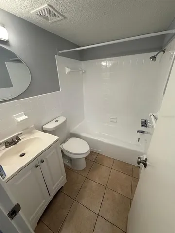 a bathroom with a toilet a sink and shower