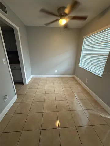 a view of an empty room with a window