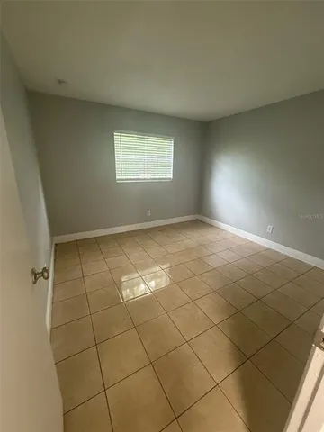 an empty room with a empty space and a window