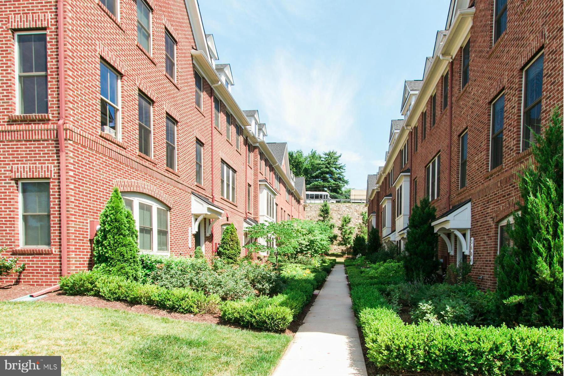 3419 Kemper Road Arlington, VA 22206 - Photo 2 of 30 a view of multi story residential apartment building with yard and bench